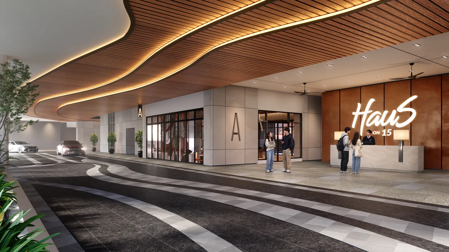 The drop-off under the curved timber canopy, with the Haus On 15 sign behind the reception desk.